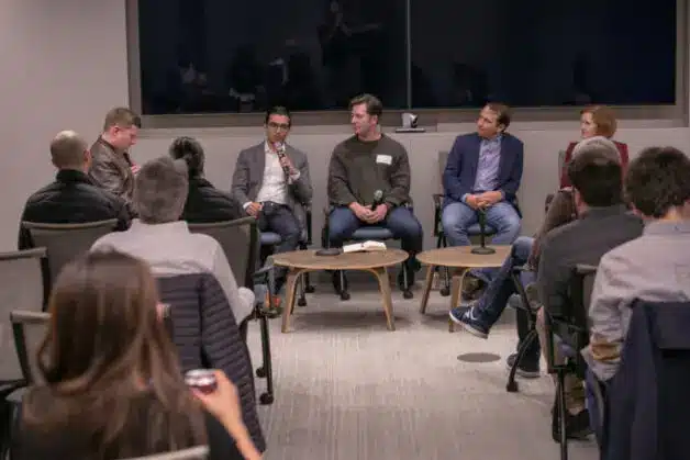 Panel discussion on digital securities regulation with several speakers and an audience.