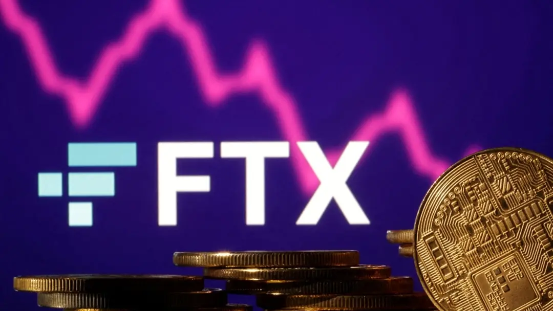 FTX crypto exchange logo on a purple screen with a declining red stock graph and gold physical coins