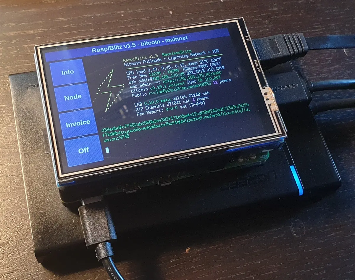 RaspiBlitz v1.5 Bitcoin and Lightning Network node running on a Raspberry Pi with a small LCD screen.