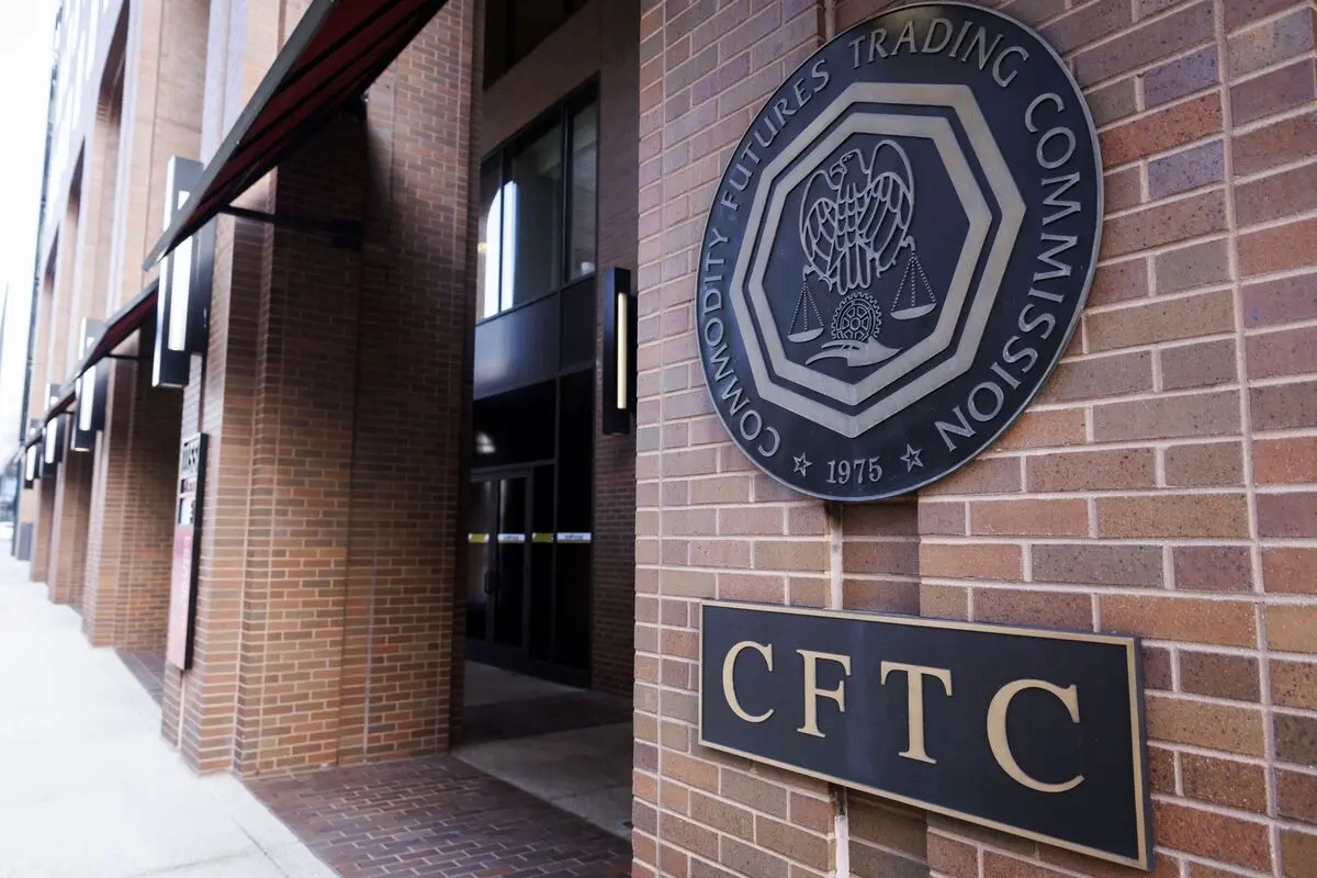 Exterior brick wall of the CFTC headquarters featuring the official seal and a gold lettered CFTC sign.