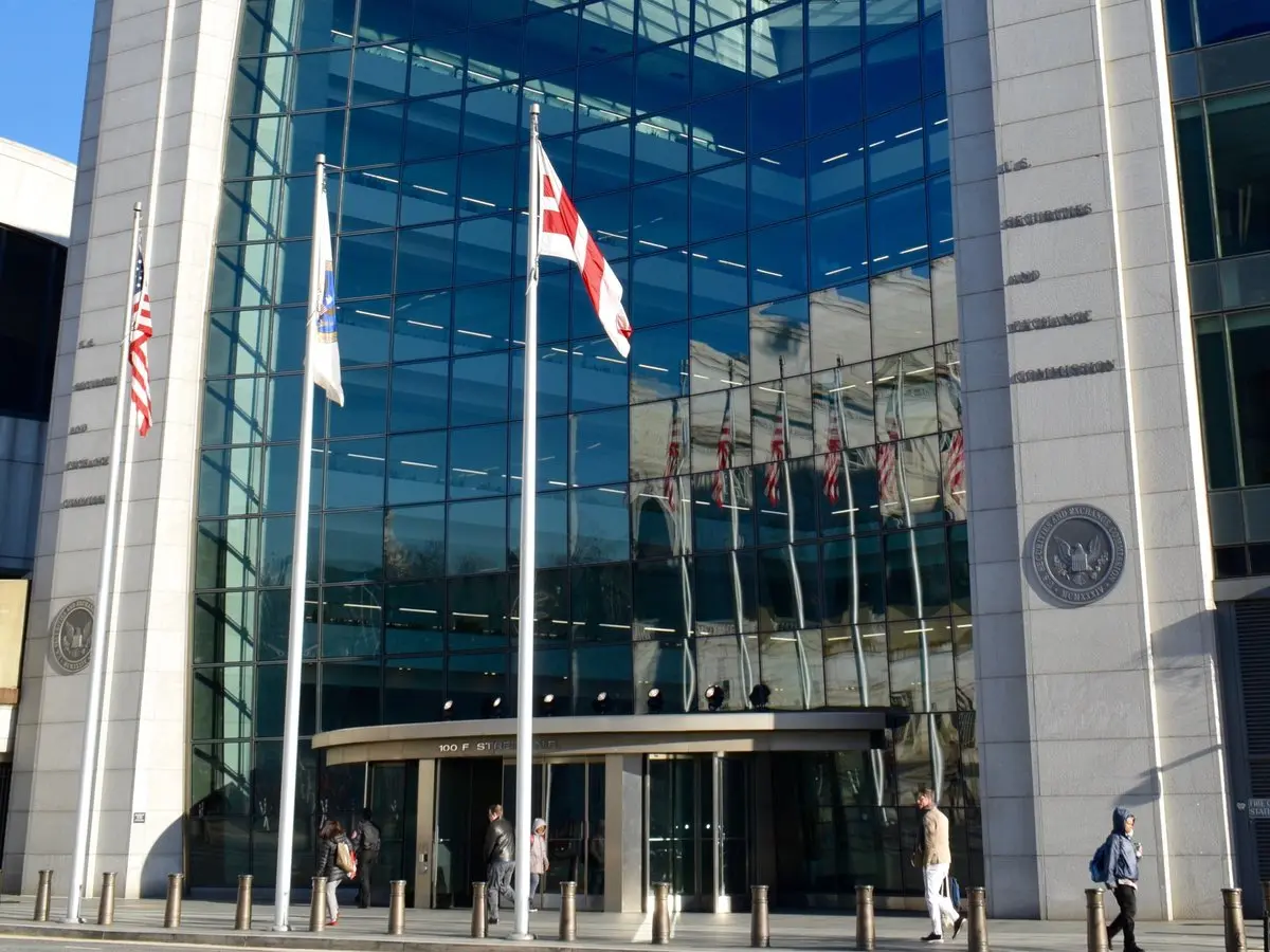 Exterior view of the Securities and Exchange Commission building in Washington, D.C. with flags in front.