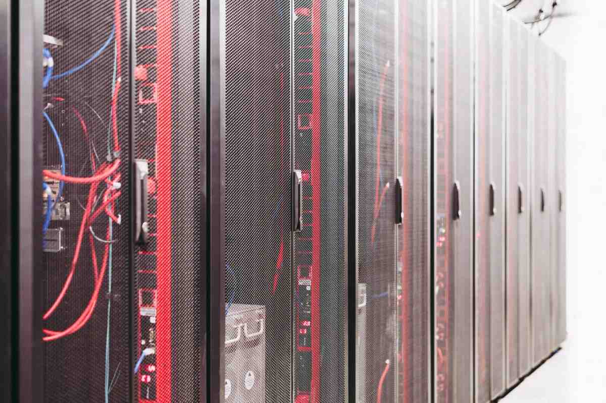 Server racks with visible wiring in a data center environment.
