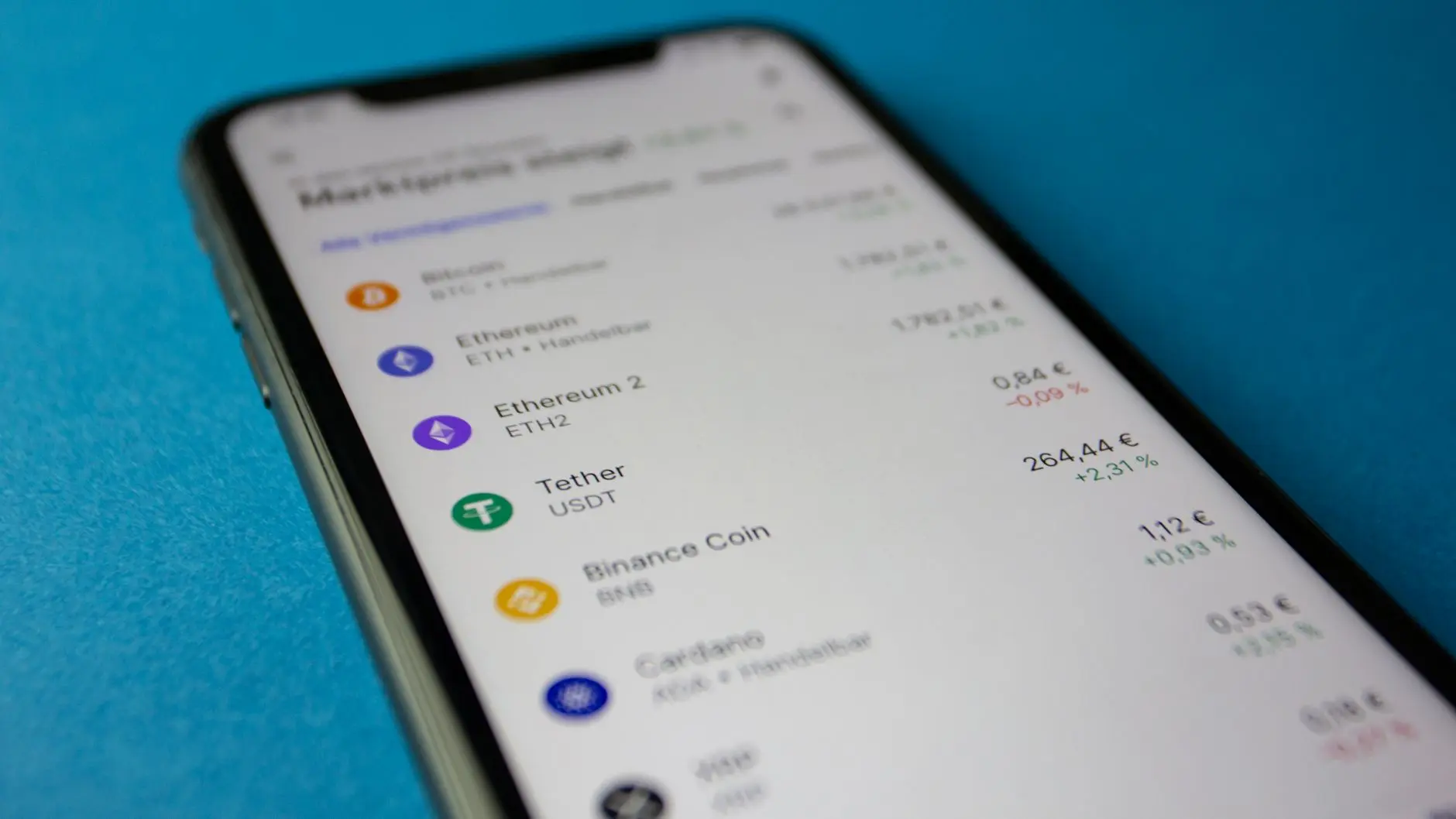 Smartphone displaying cryptocurrency market prices and values.