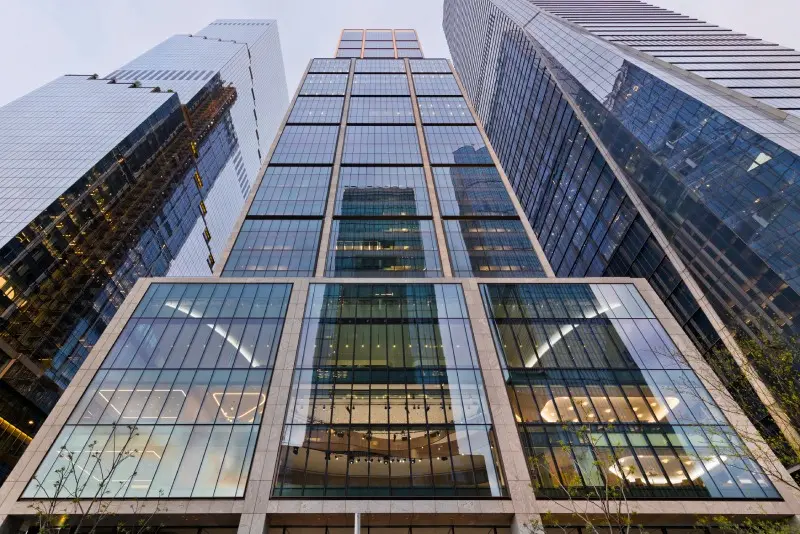 Low-angle view of the modern glass and steel BlackRock headquarters skyscraper in New York City