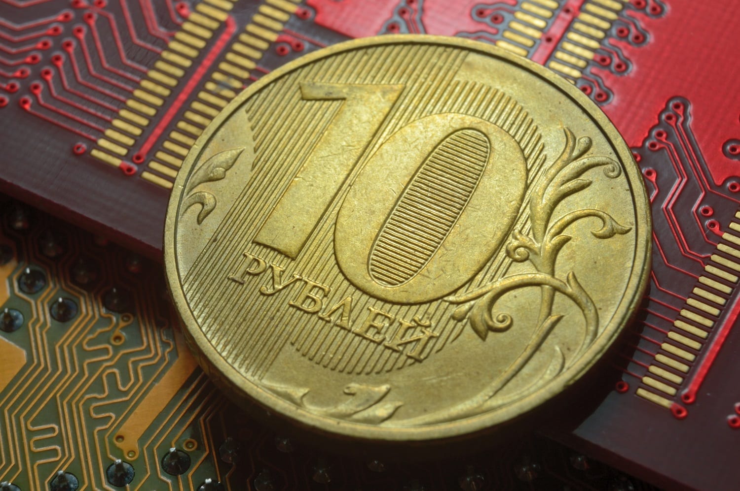 A Russian 10-ruble coin lies on several microcircuits.