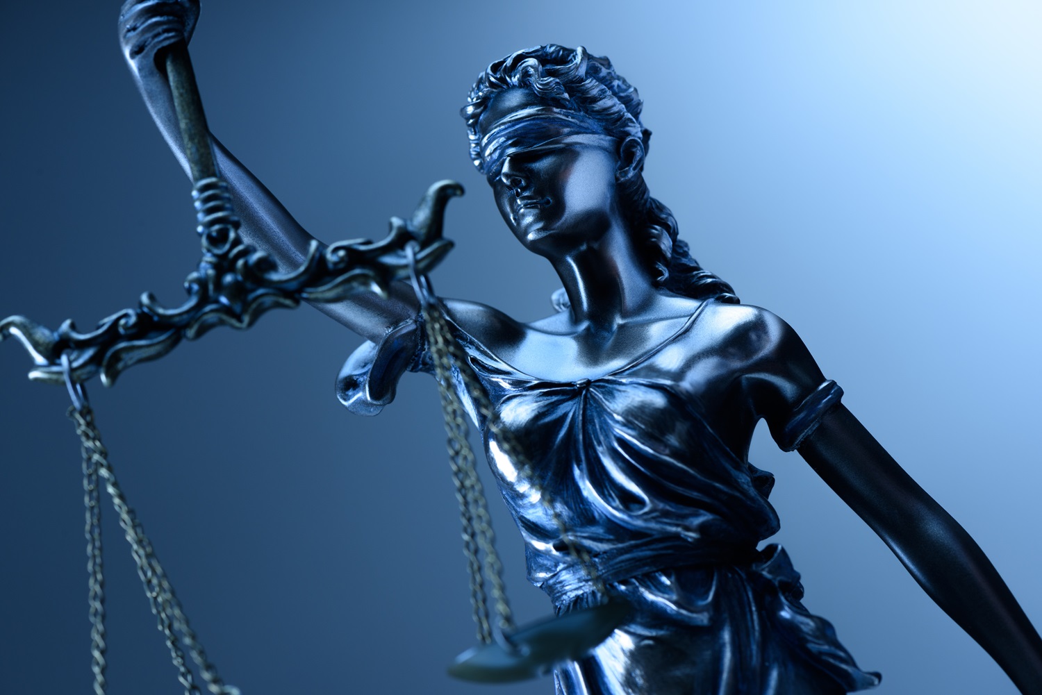 A statue of Lady Justice holding a set of scales.