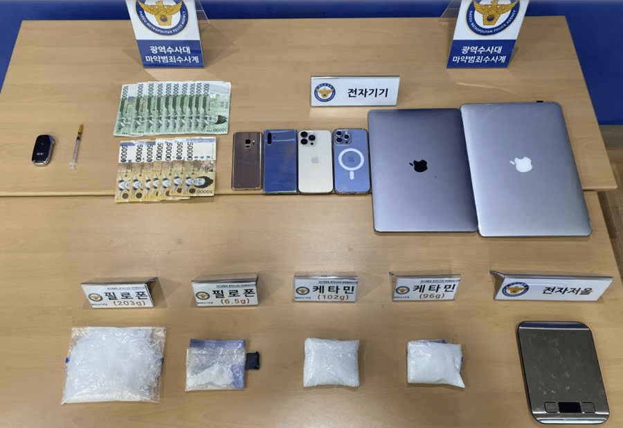 Items seized by police during the raids, including bags of methamphetamine and ketamine, cash, and electronic devices.