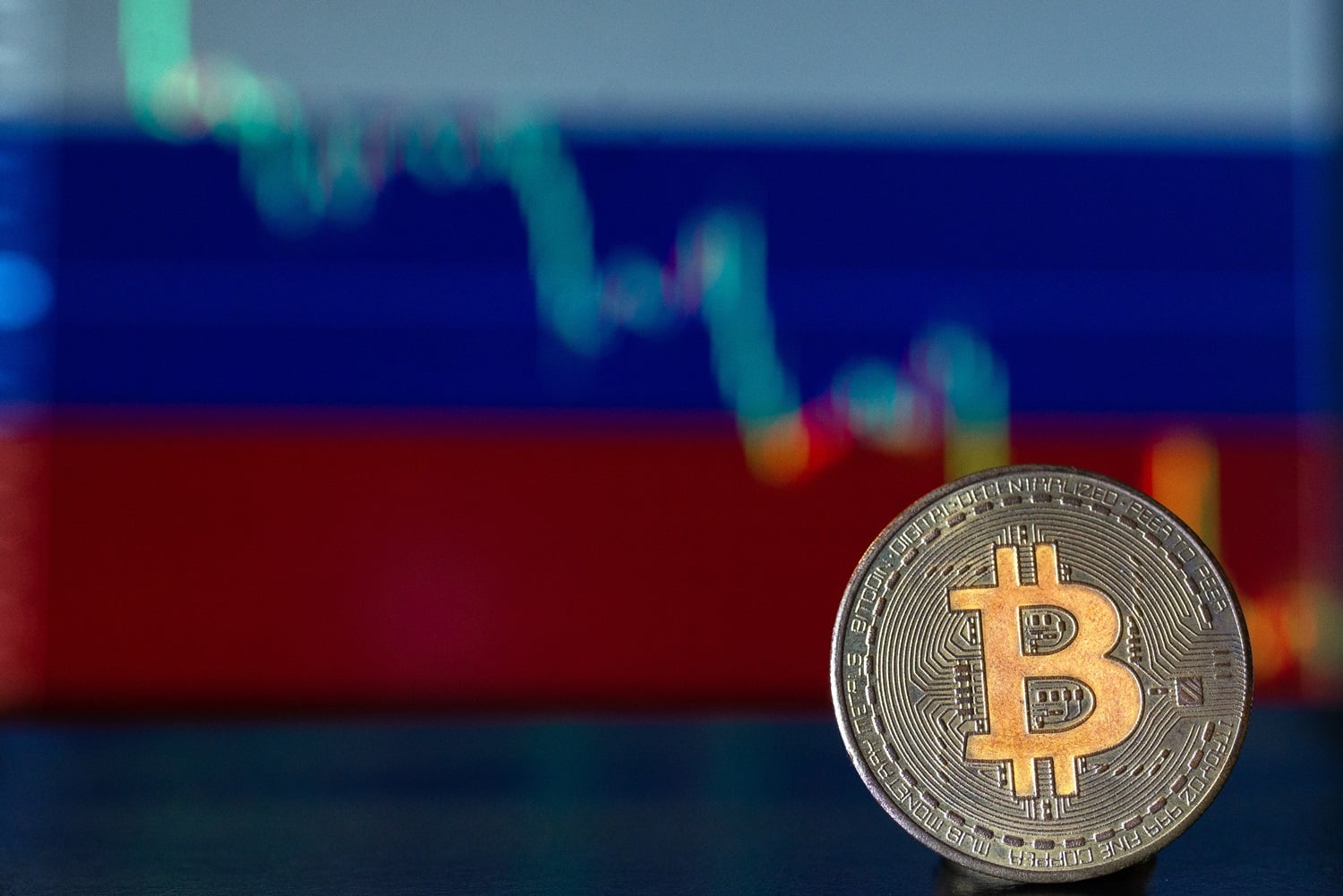 A token intended to represent Bitcoin against the background of the Russian flag and a graph.
