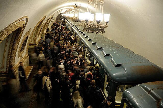 Passengers board and alight from a train in a station on the Moscow Metro.
