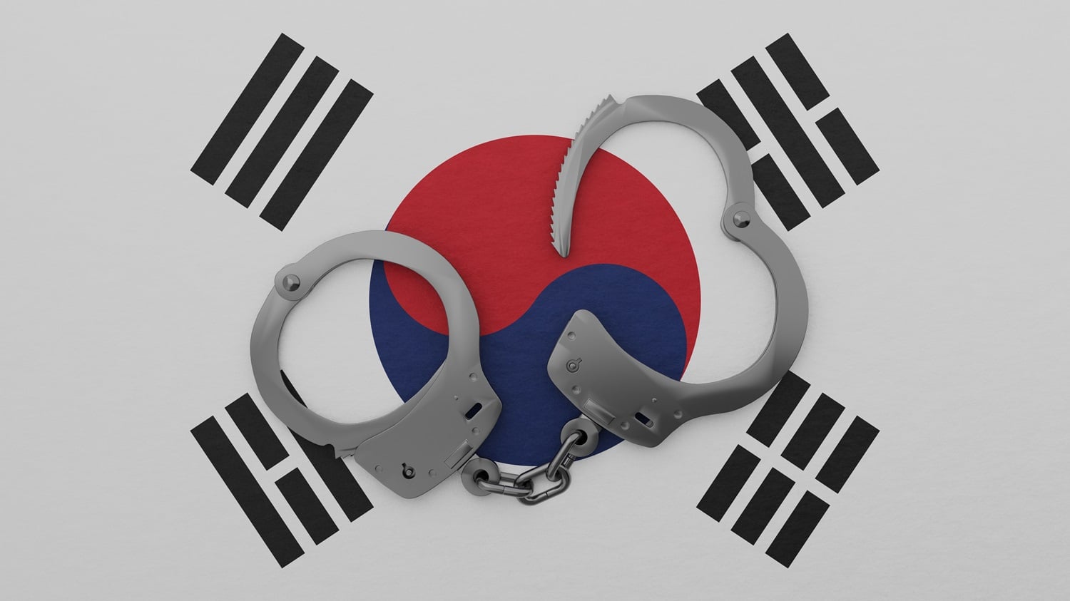 A half-opened set of steel handcuffs against the background of the South Korean flag