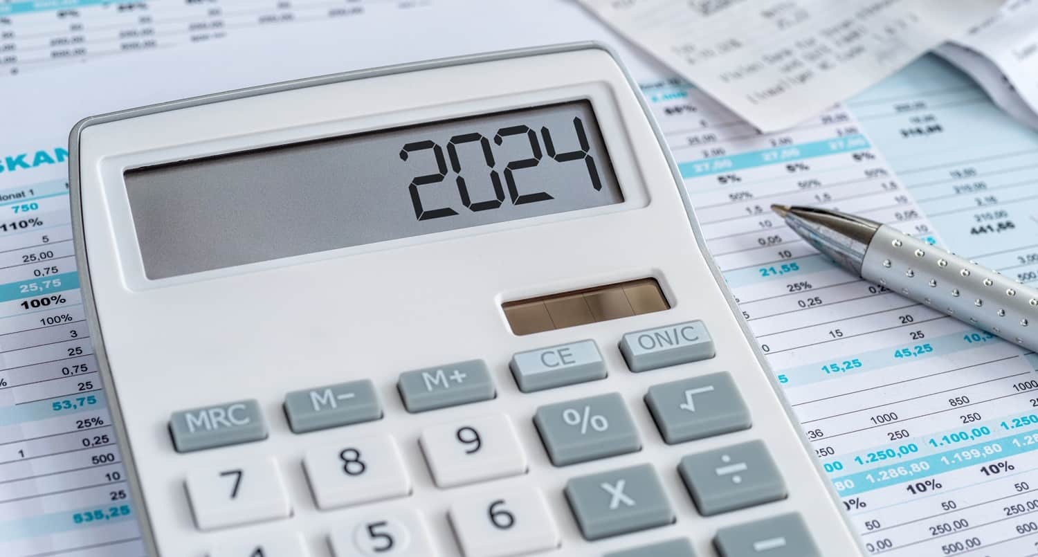 A printout with financial information with a calculator with the 2024 on its display next to a pen. WeMade