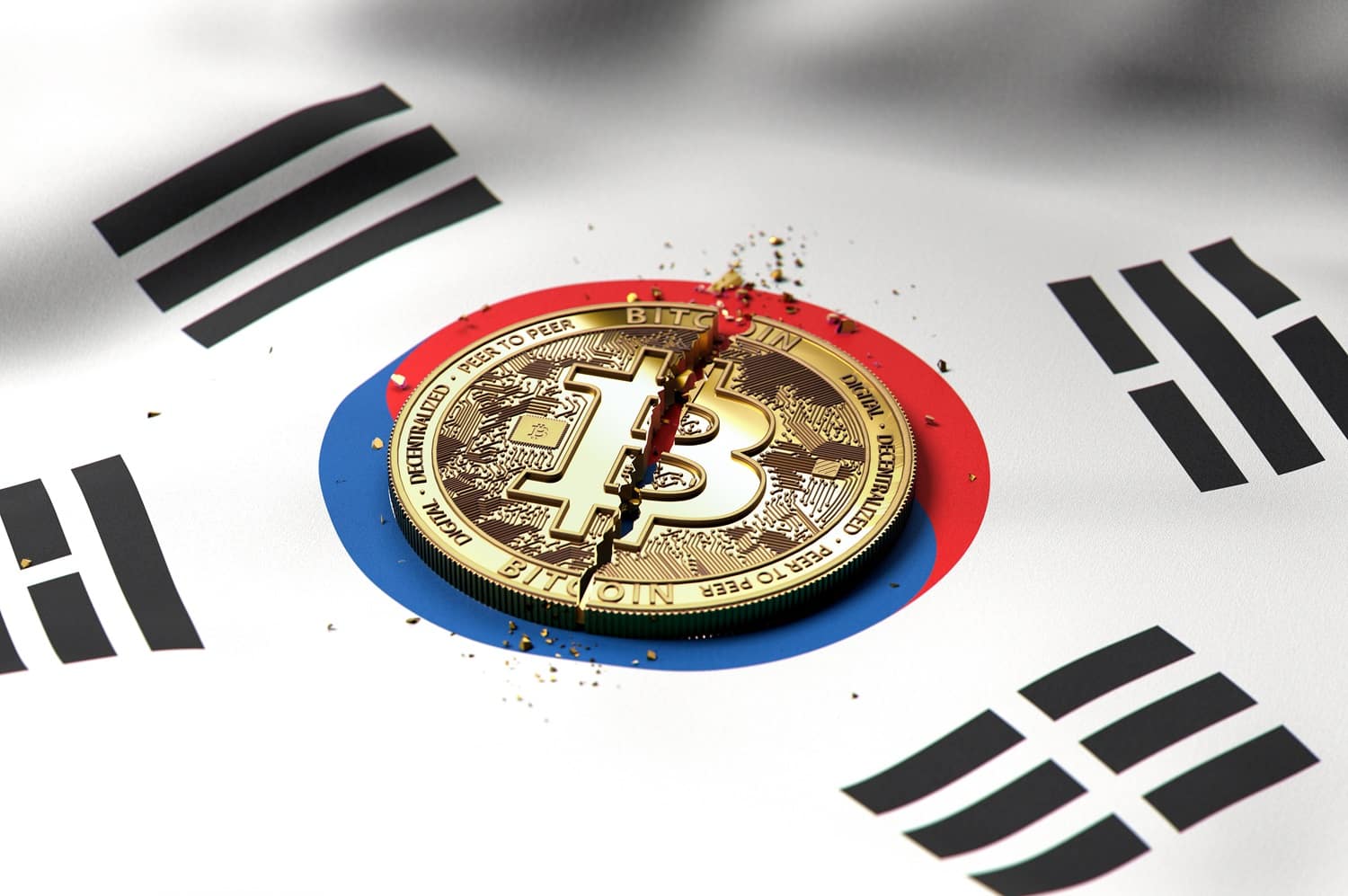 A cracked metal token intended to represent Bitcoin rests on the South Korean flag.