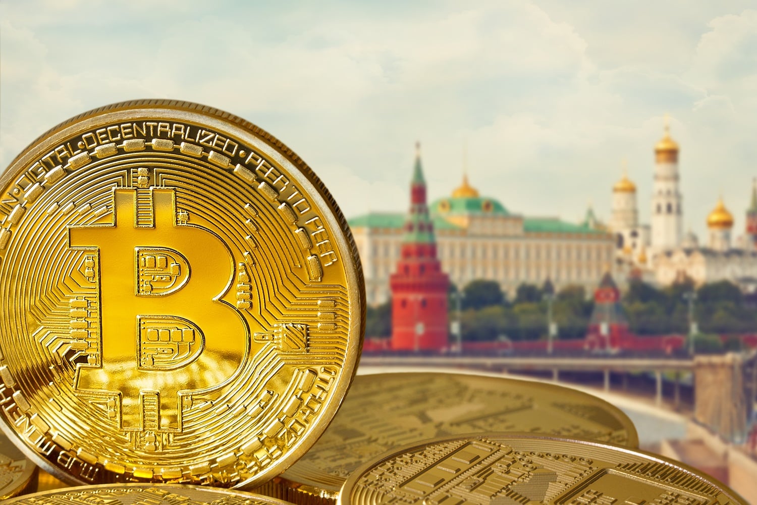 Metal tokens intended to represent Bitcoin against the background of the Kremlin in Moscow, Russia.