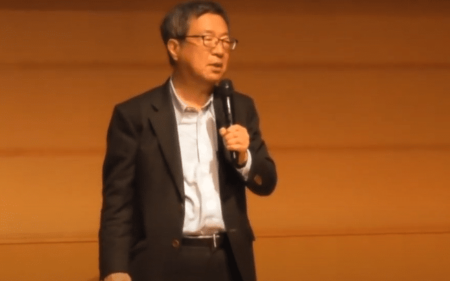 The lawmaker Takeshi Fujimaki speaking at the Tezos Japan Meetup in 2019.