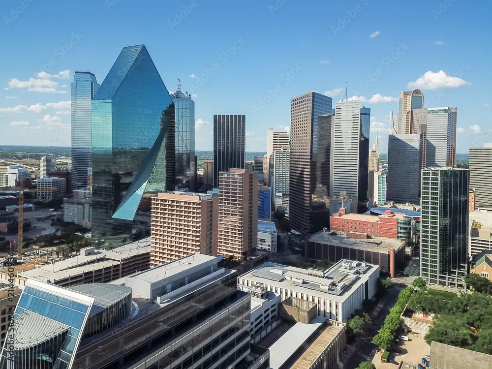 View of skyscrapers in a commercial banking district cityscape under a clear blue sky.
