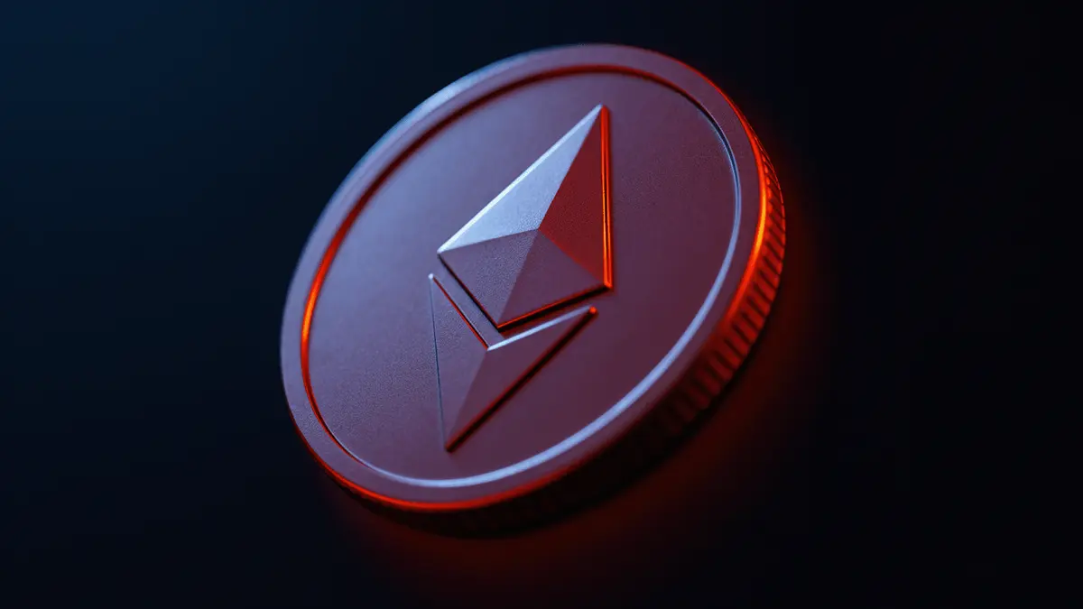 Ethereum cryptocurrency coin tilted downward against dark background with red warning lighting